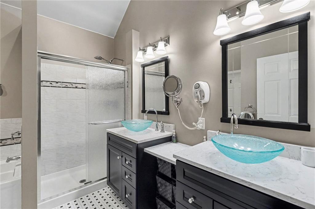 65 Indian Hills Drive Rydal, GA 30171 - Photo 18 of 32 a bathroom with a granite countertop sink a mirror and shower