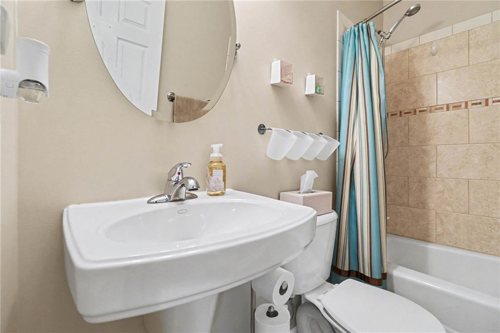 65 Indian Hills Drive Rydal, GA 30171 - Photo 19 of 32 a bathroom with a sink a toilet and shower