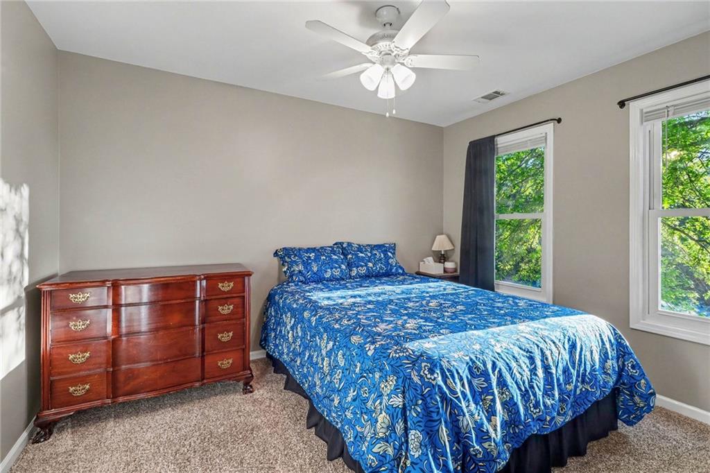 65 Indian Hills Drive Rydal, GA 30171 - Photo 20 of 32 a bedroom with a bed dresser and a window