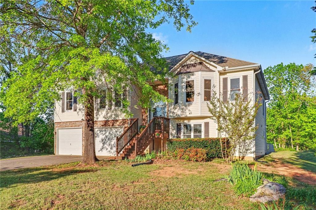 65 Indian Hills Drive Rydal, GA 30171 - Photo 2 of 32 a front view of a house with a yard