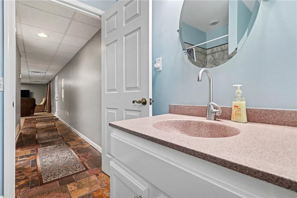 65 Indian Hills Drive Rydal, GA 30171 - Photo 23 of 32 a en suite bathroom with a granite countertop sink and a mirror