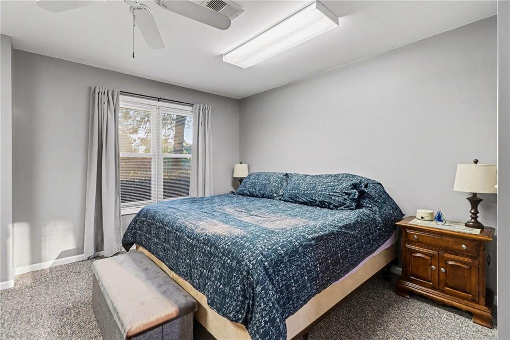 65 Indian Hills Drive Rydal, GA 30171 - Photo 27 of 32 a bedroom with a bed and wooden floor