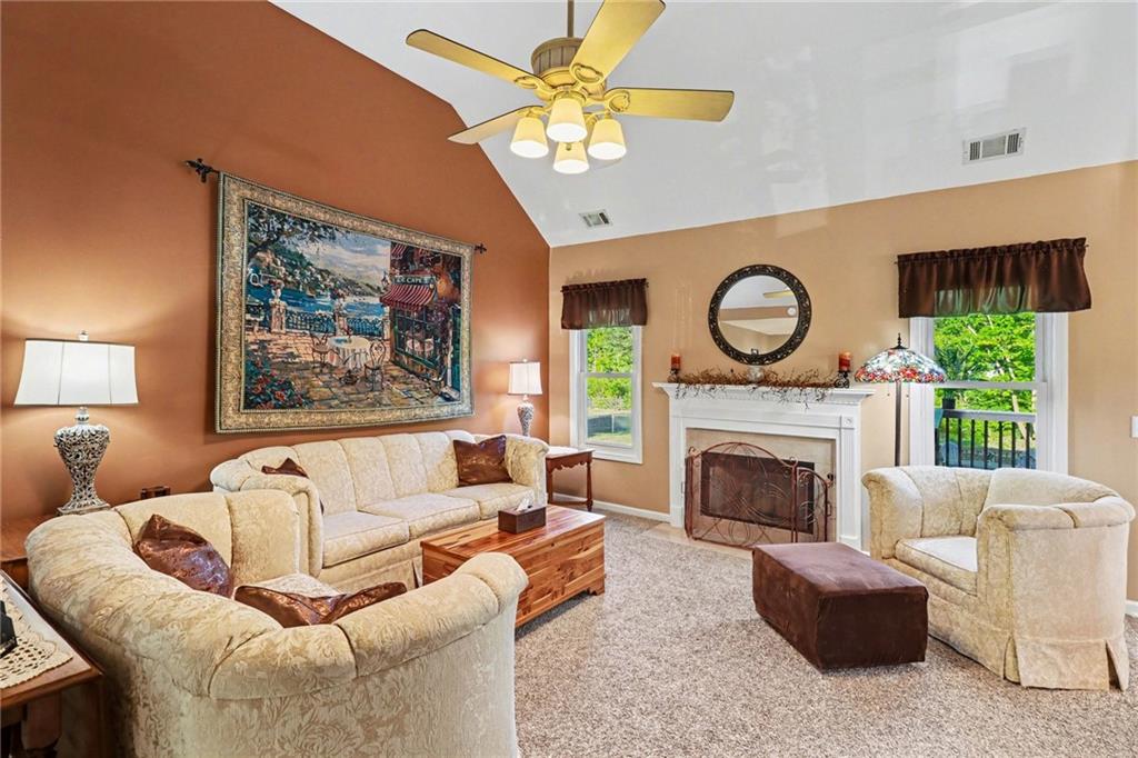 65 Indian Hills Drive Rydal, GA 30171 - Photo 6 of 32 a living room with furniture a clock and a fireplace