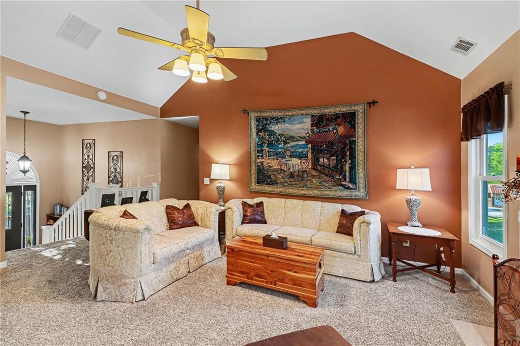 65 Indian Hills Drive Rydal, GA 30171 - Photo 7 of 32 a living room with furniture a chandelier and a window