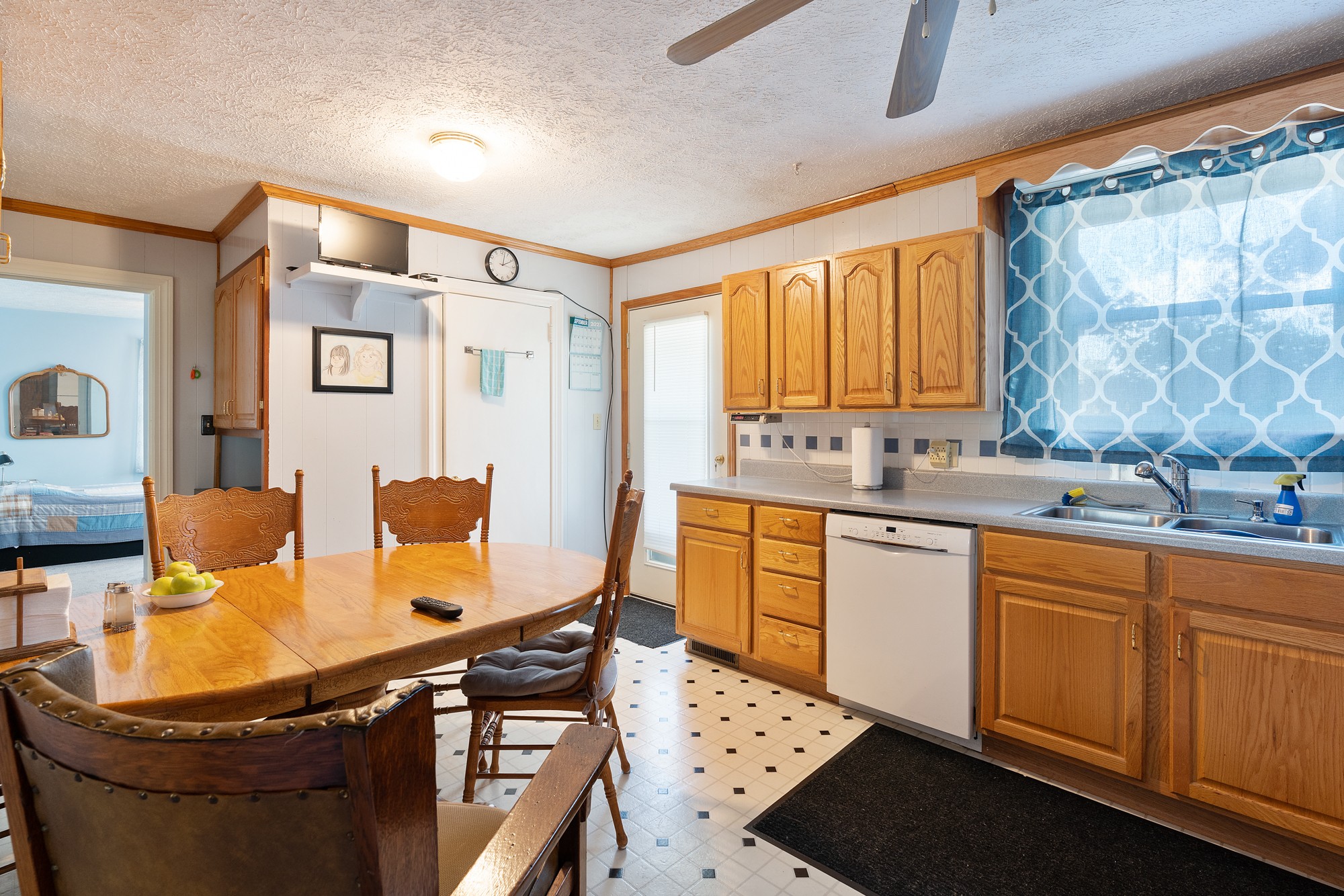 8915 Lyles Road Lyles, TN 37098 - Photo 12 of 39 a kitchen with stainless steel appliances granite countertop a sink dishwasher stove a microwave oven with a dining table and chairs with wooden floor
