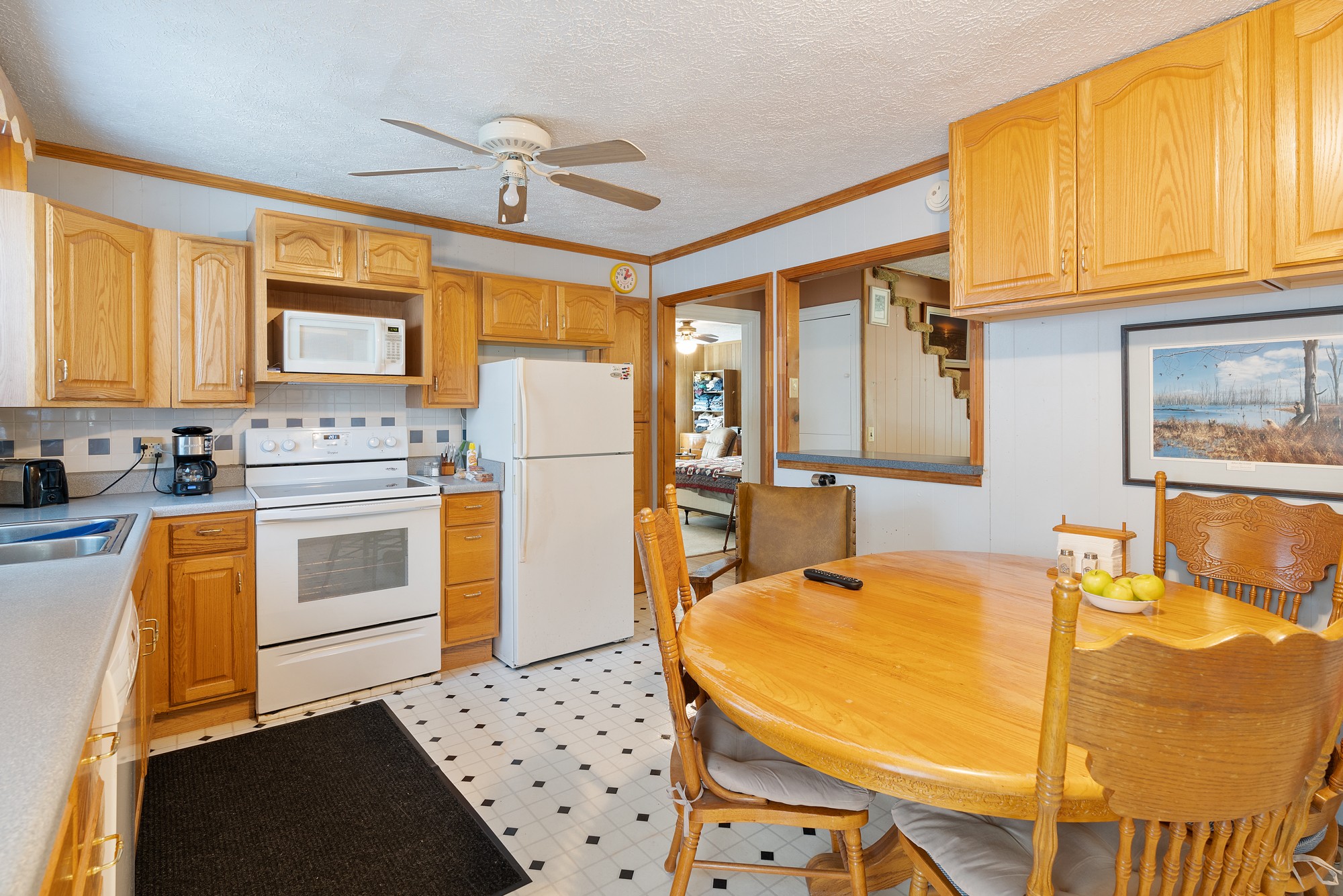 8915 Lyles Road Lyles, TN 37098 - Photo 13 of 39 a kitchen with stainless steel appliances a stove a refrigerator cabinets and a dining table