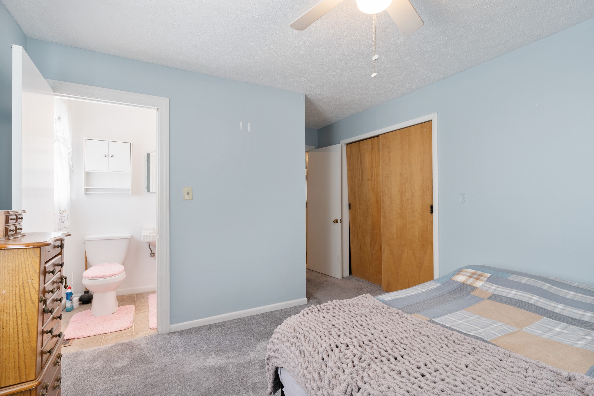 8915 Lyles Road Lyles, TN 37098 - Photo 18 of 39 a bedroom with a bed and a painting on the wall