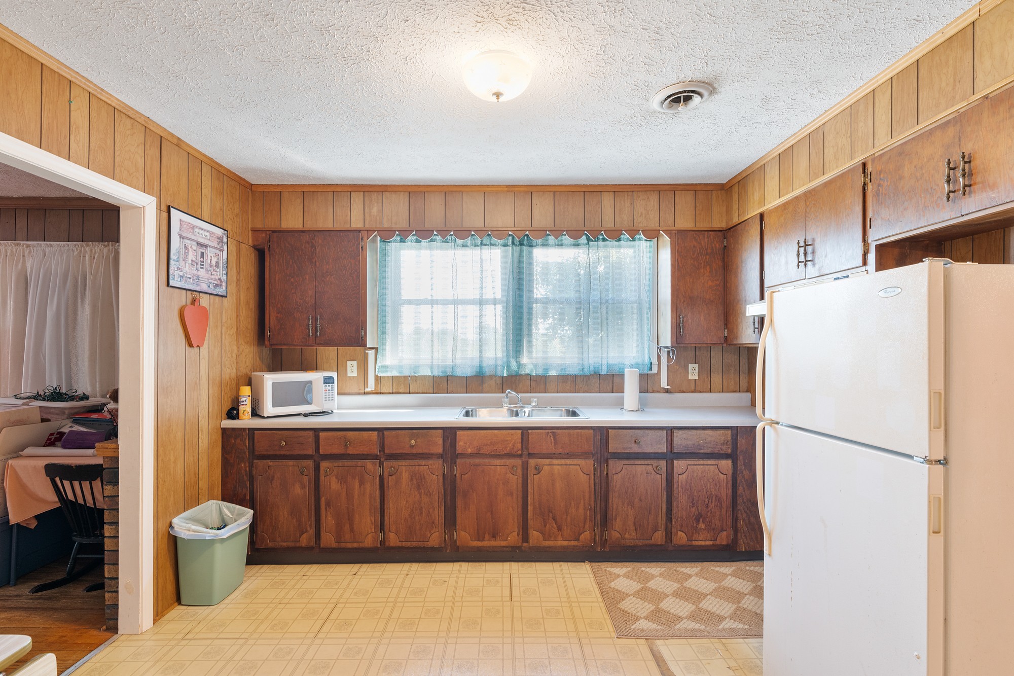 8915 Lyles Road Lyles, TN 37098 - Photo 20 of 39 a kitchen with a sink a refrigerator and a stove