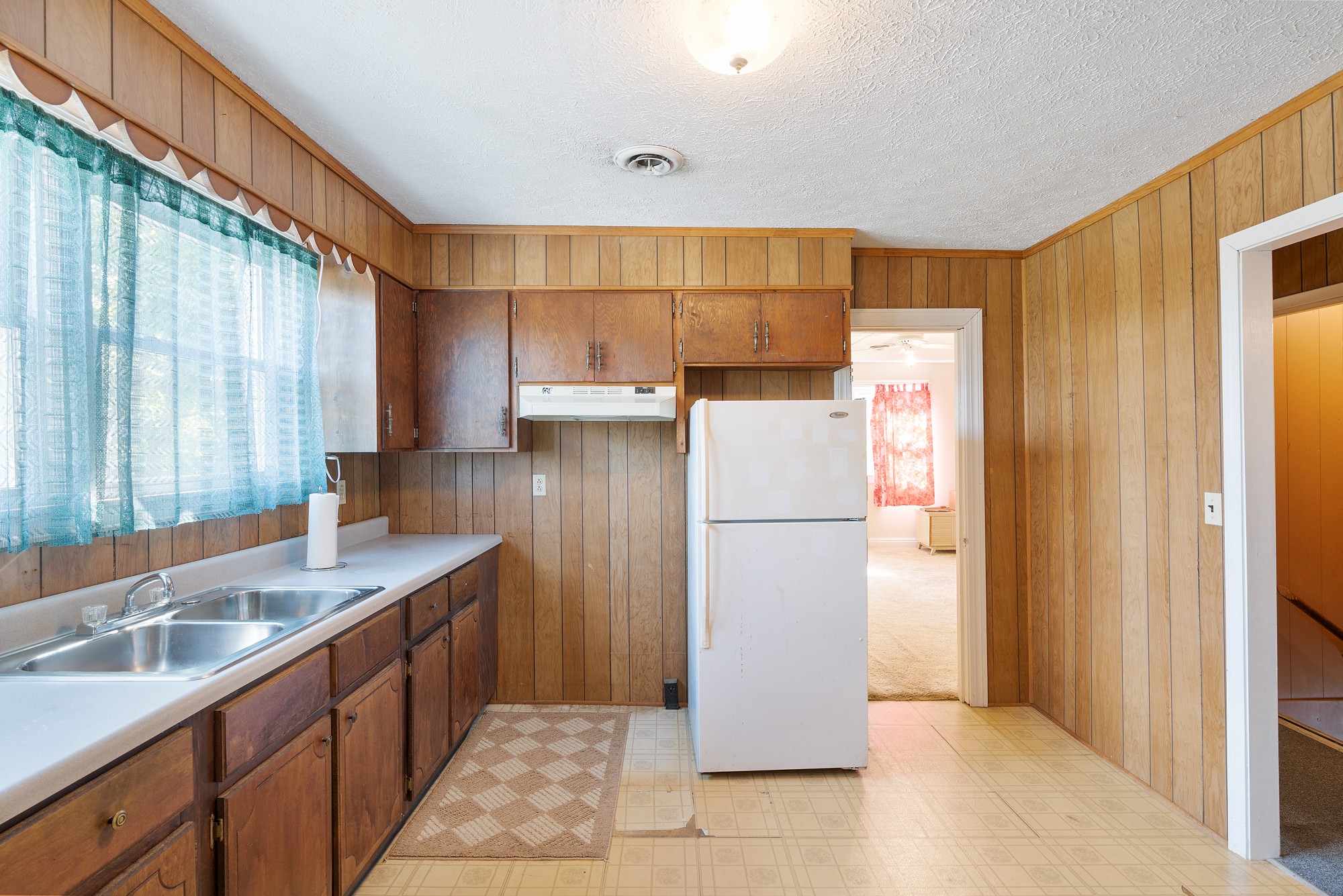 8915 Lyles Road Lyles, TN 37098 - Photo 21 of 39 a kitchen with a sink a refrigerator and a window