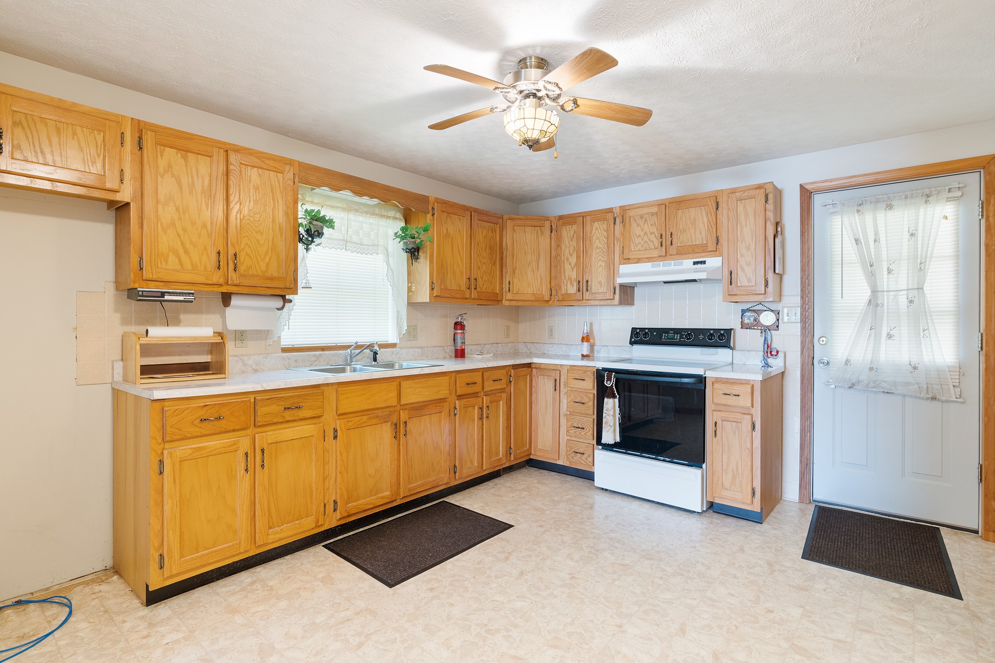 8915 Lyles Road Lyles, TN 37098 - Photo 32 of 39 a kitchen with stainless steel appliances granite countertop a stove a sink dishwasher and a refrigerator