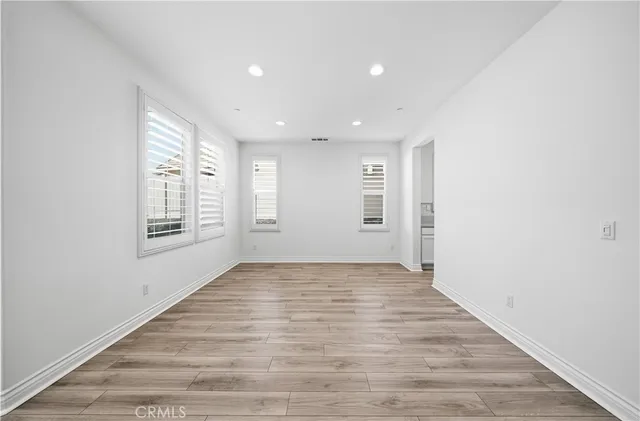 a view of a livingroom with wooden floor and stairs