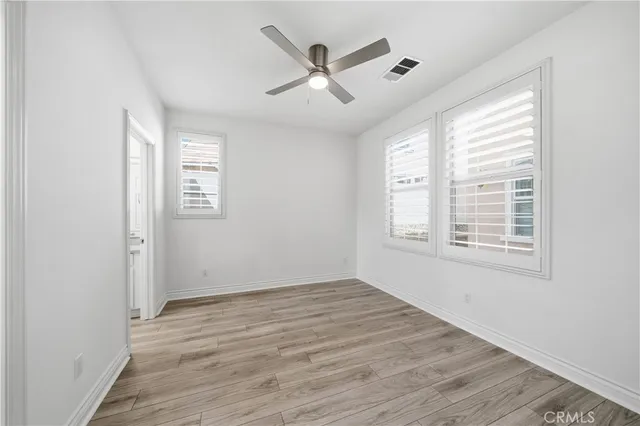 a bathroom with a granite countertop toilet a sink and a mirror