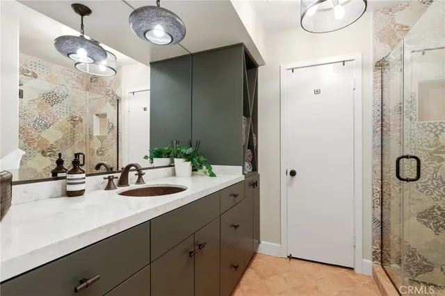 a bedroom with a large bed and a large mirror