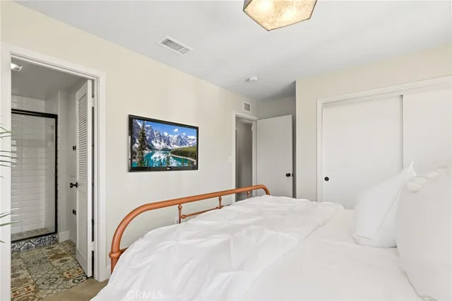 a bedroom with a bed and a dresser