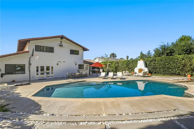 an aerial view of house with yard and mountain view in back