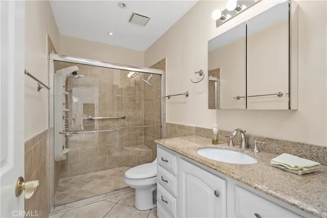 a bedroom with a bed and a refrigerator