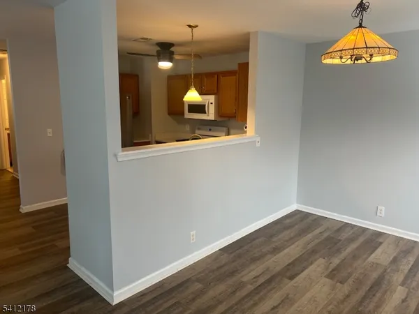 a view of a room with wooden floor and door