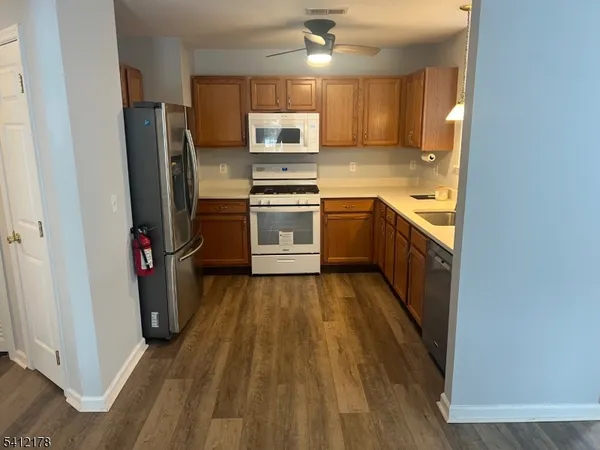 a kitchen with stainless steel appliances a refrigerator and a stove top oven
