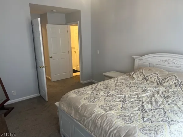 a bedroom with a bed and a mirror