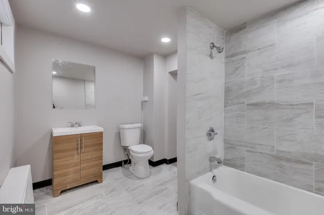 a bathroom with a bathtub a toilet and a shower