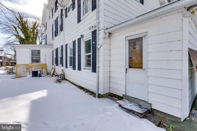 a view of a house with a wooden fence