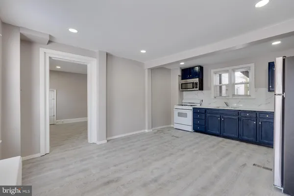 a spacious bathroom with a granite countertop sink and a mirror
