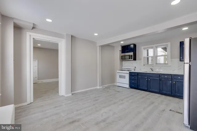 a spacious bathroom with a granite countertop sink and a mirror