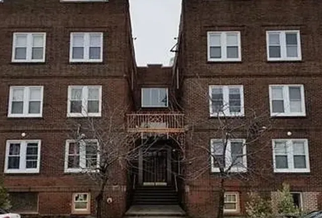 a front view of a building with many windows