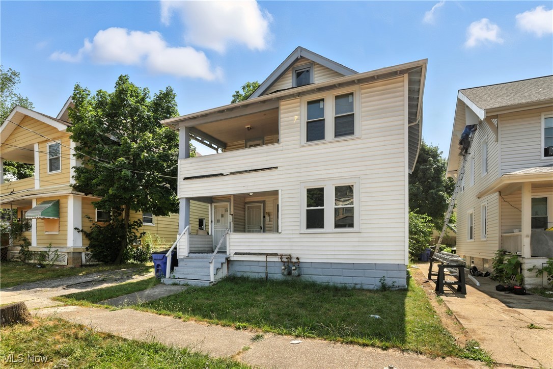 1774 Urbana Road Cleveland, OH 44112 - Photo 36 of 41 View of front of house featuring a balcony, covered porch, and a front lawn