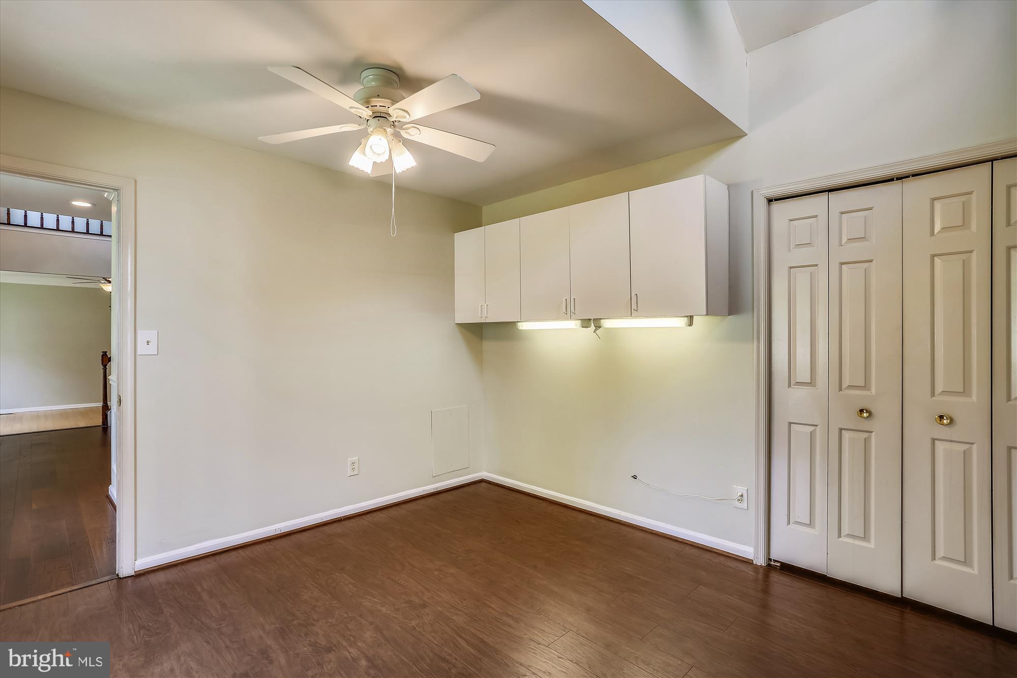 8908 Spring Berry Court Gaithersburg, MD 20886 - Photo 17 of 59 Main Level bedroom with hardwood floors, built-ins