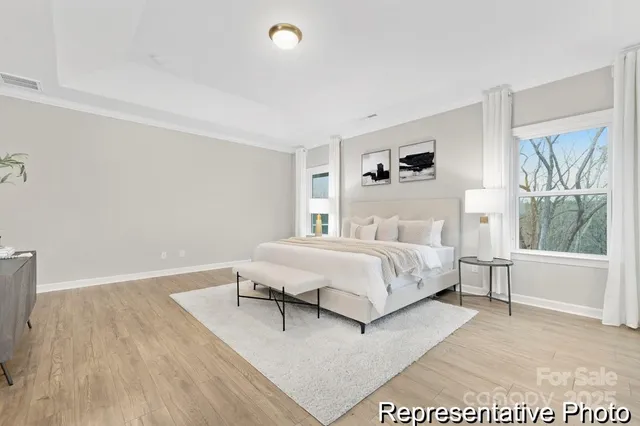 a bedroom with a bed and a large window