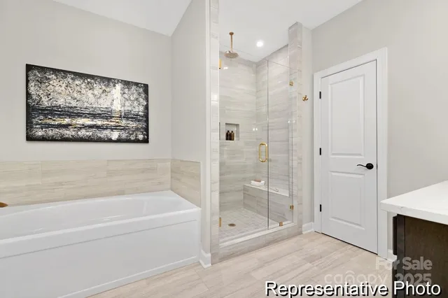 a bathroom with a glass shower door and a shower
