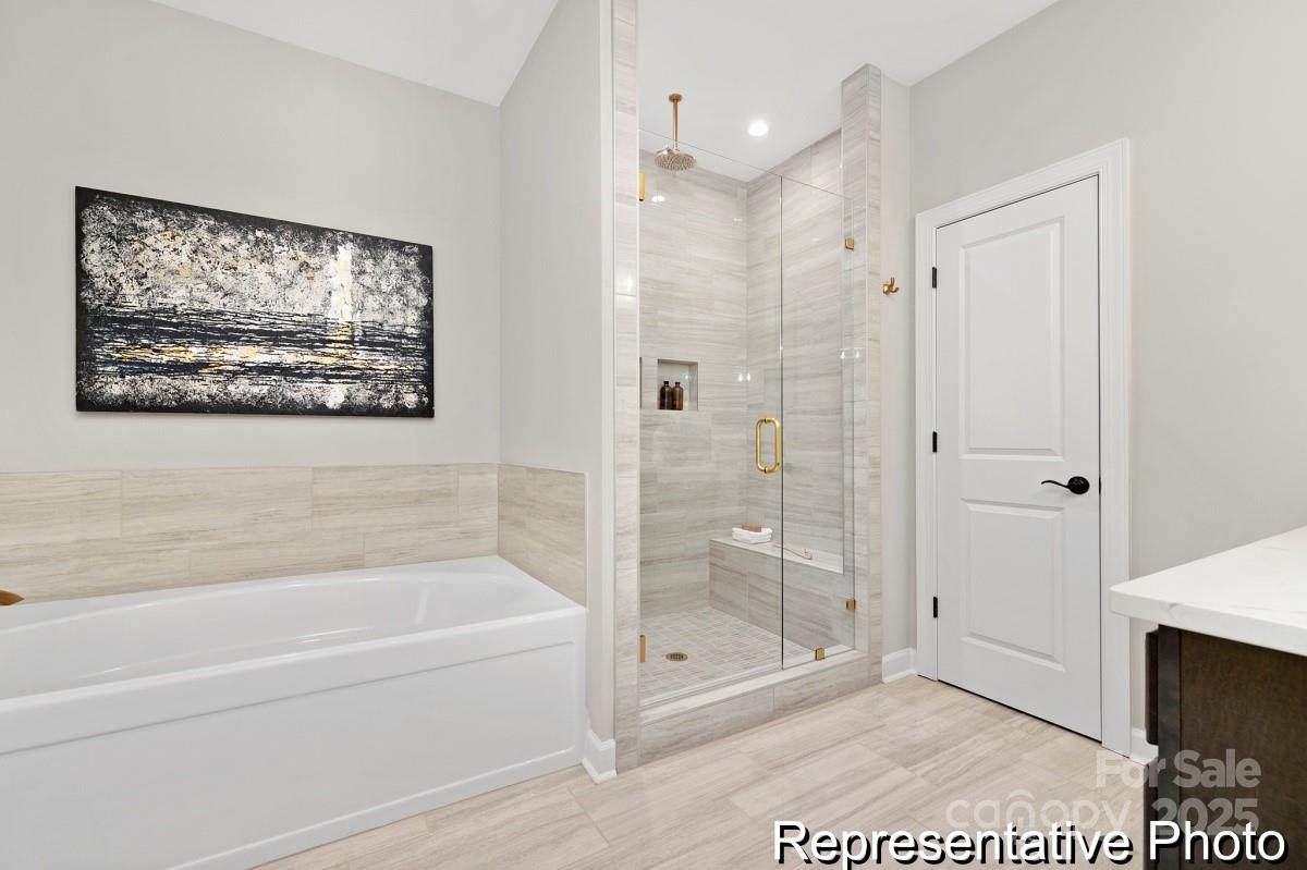 4114 McManus Road, Unit 1P Monroe, NC 28112 - Photo 18 of 37 a bathroom with a glass shower door and a shower