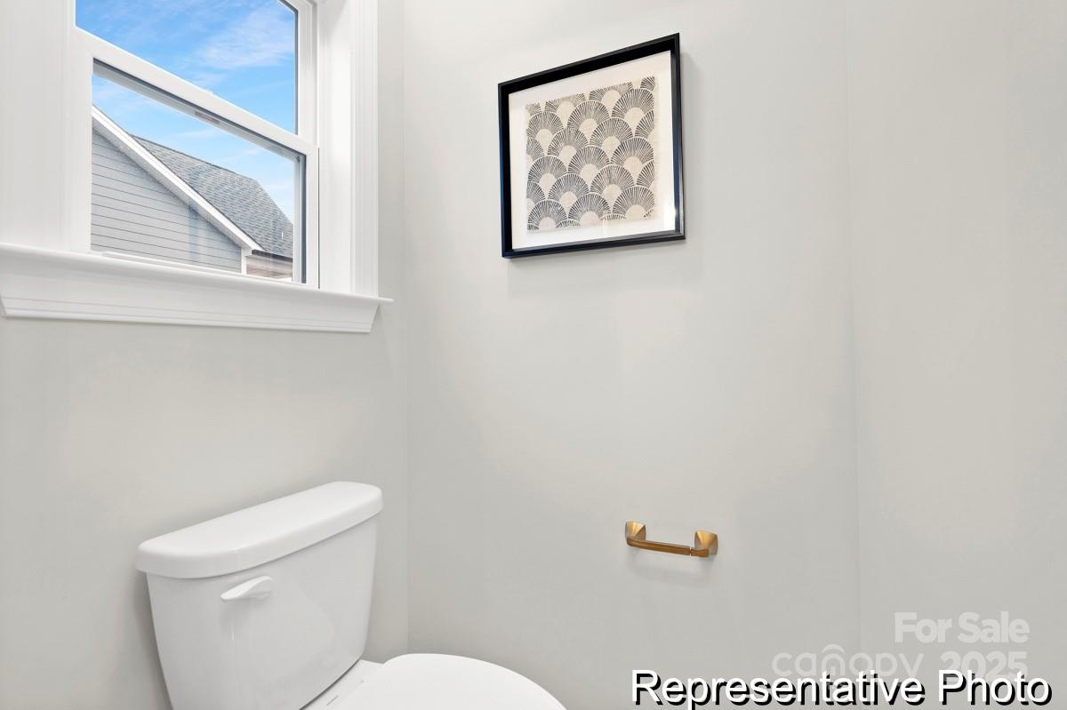 4114 McManus Road, Unit 1P Monroe, NC 28112 - Photo 21 of 37 a white toilet sitting next to a bathroom sink