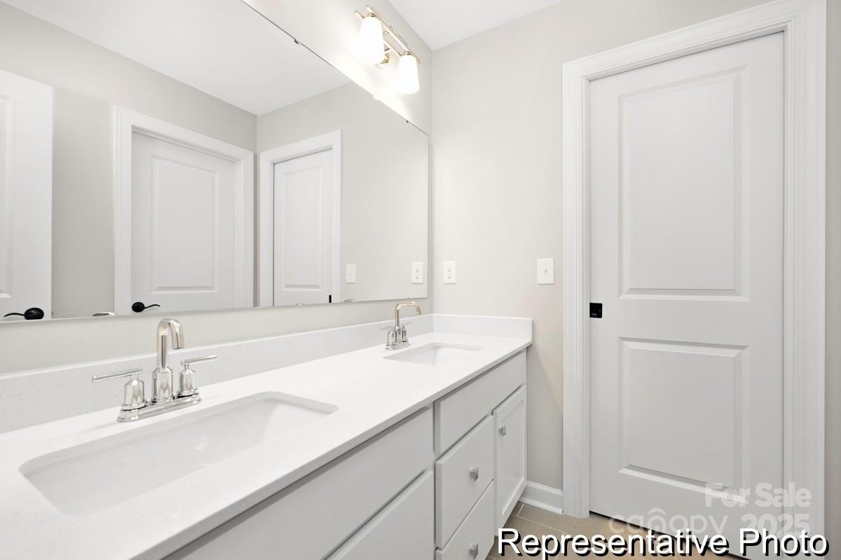 4114 McManus Road, Unit 1P Monroe, NC 28112 - Photo 31 of 37 a bathroom with a sink and a mirror