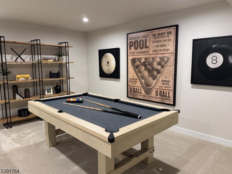 a room with pool table and wall paintings