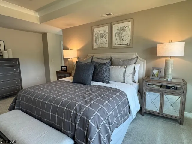 a bedroom with a bed and a lamp