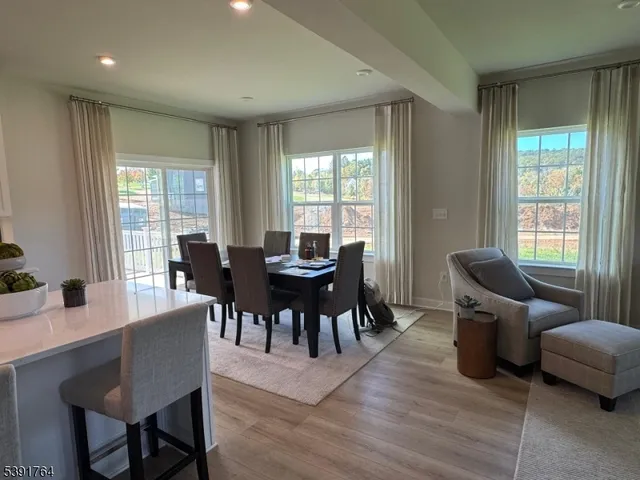 a view of a dining room with furniture and windows
