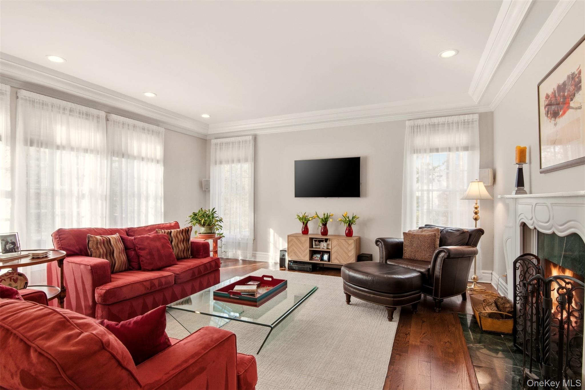 4 Daniel Way Setauket, NY 11733 - Photo 13 of 50 a living room with furniture fireplace and a flat screen tv