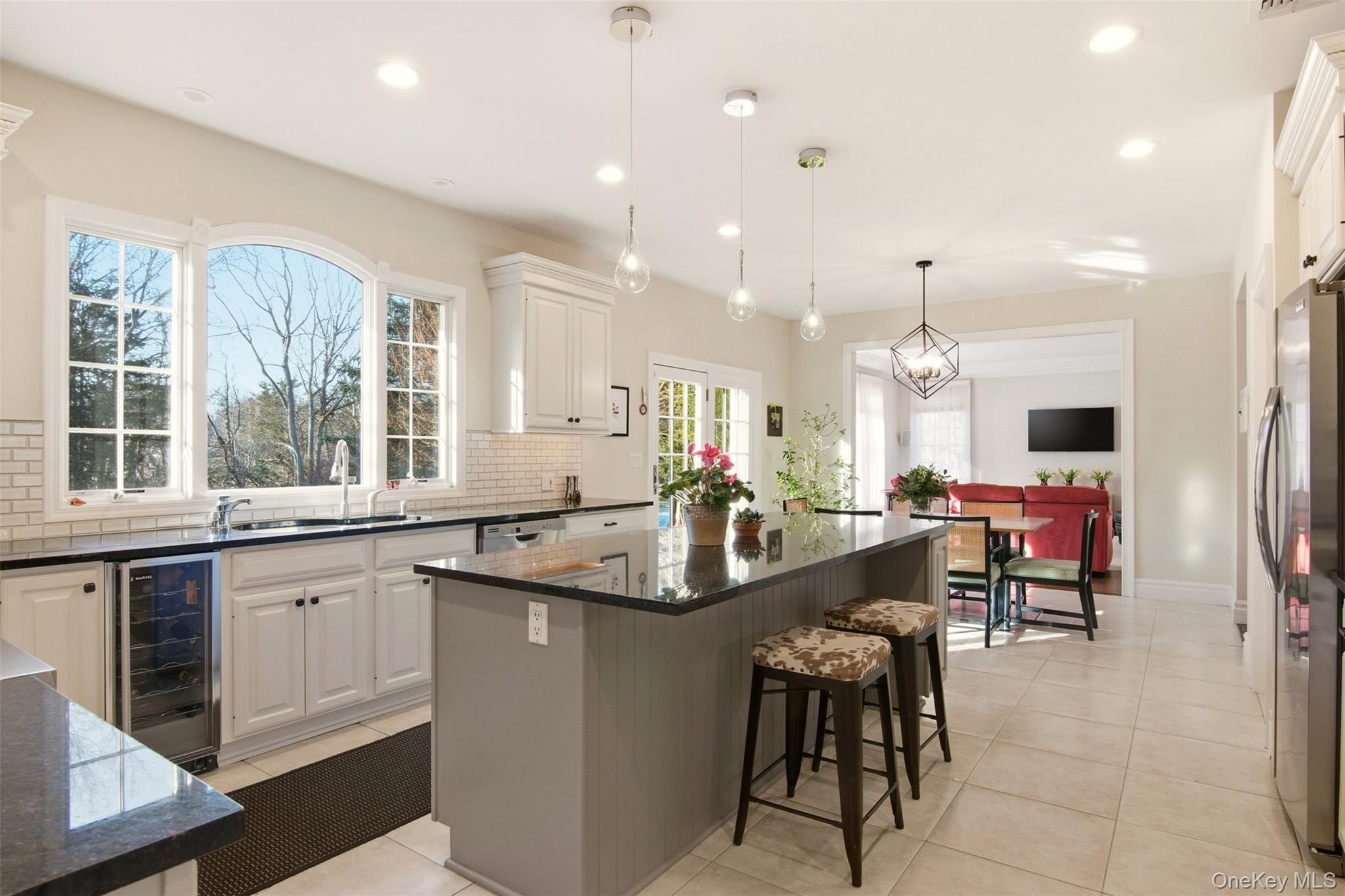 4 Daniel Way Setauket, NY 11733 - Photo 17 of 50 a kitchen with center island table and chairs in it