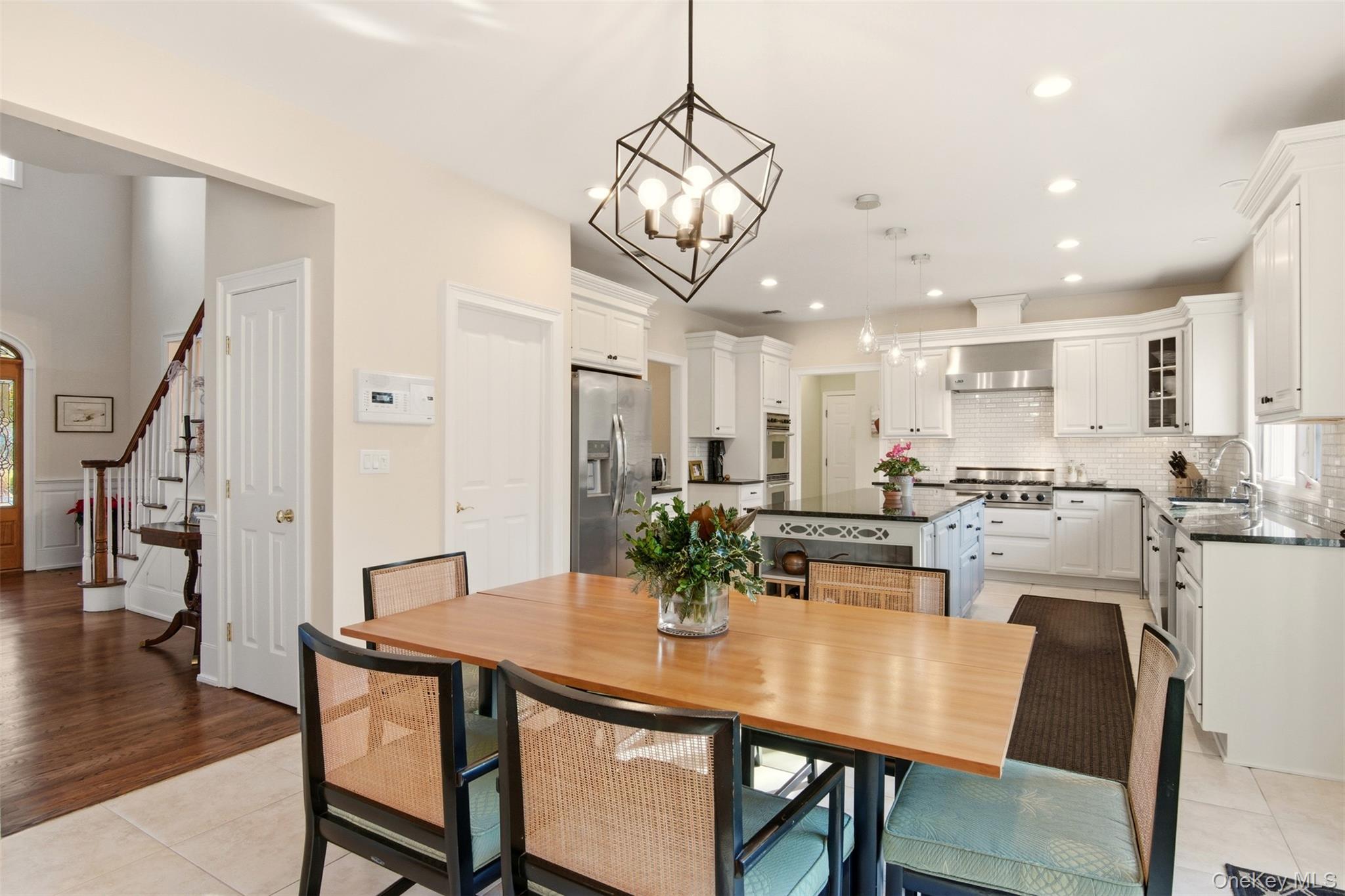 4 Daniel Way Setauket, NY 11733 - Photo 21 of 50 a view of a dining room and livingroom with furniture wooden floor a chandelier