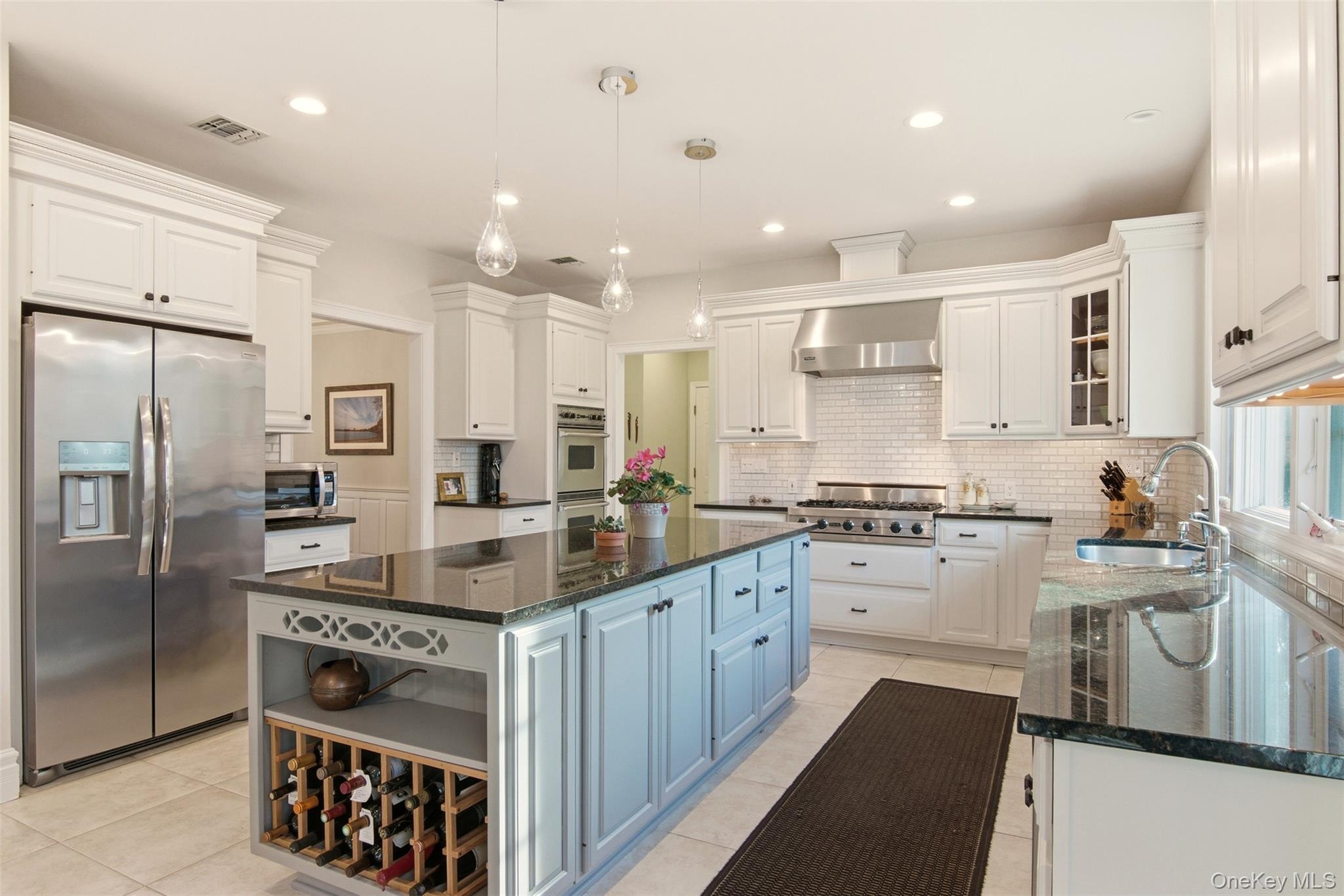 4 Daniel Way Setauket, NY 11733 - Photo 22 of 50 a kitchen with stainless steel appliances granite countertop a sink stove and refrigerator