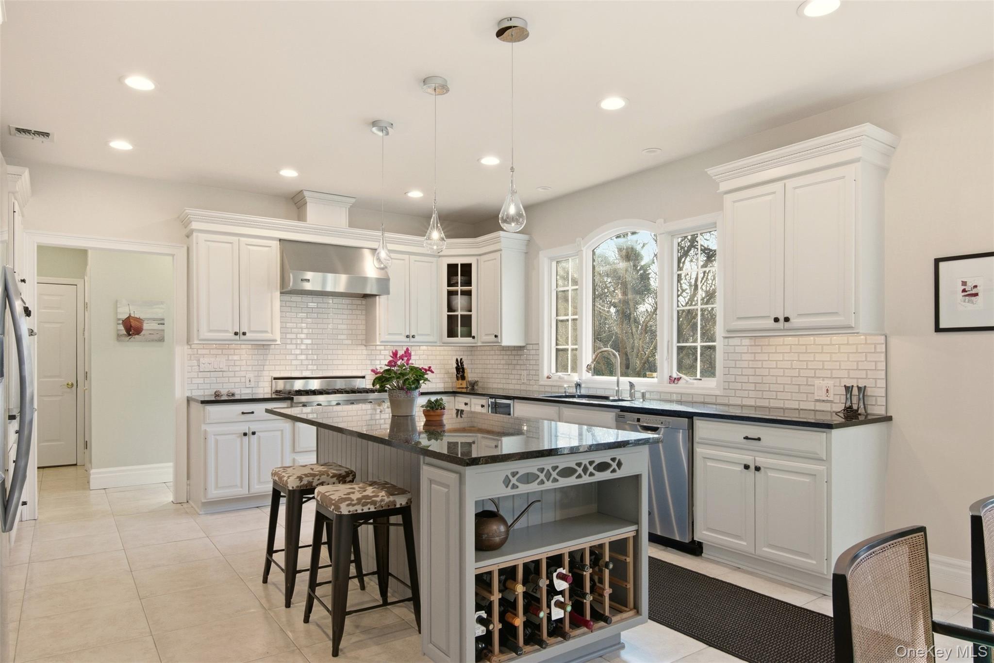 4 Daniel Way Setauket, NY 11733 - Photo 23 of 50 a kitchen with kitchen island granite countertop a sink stove and refrigerator