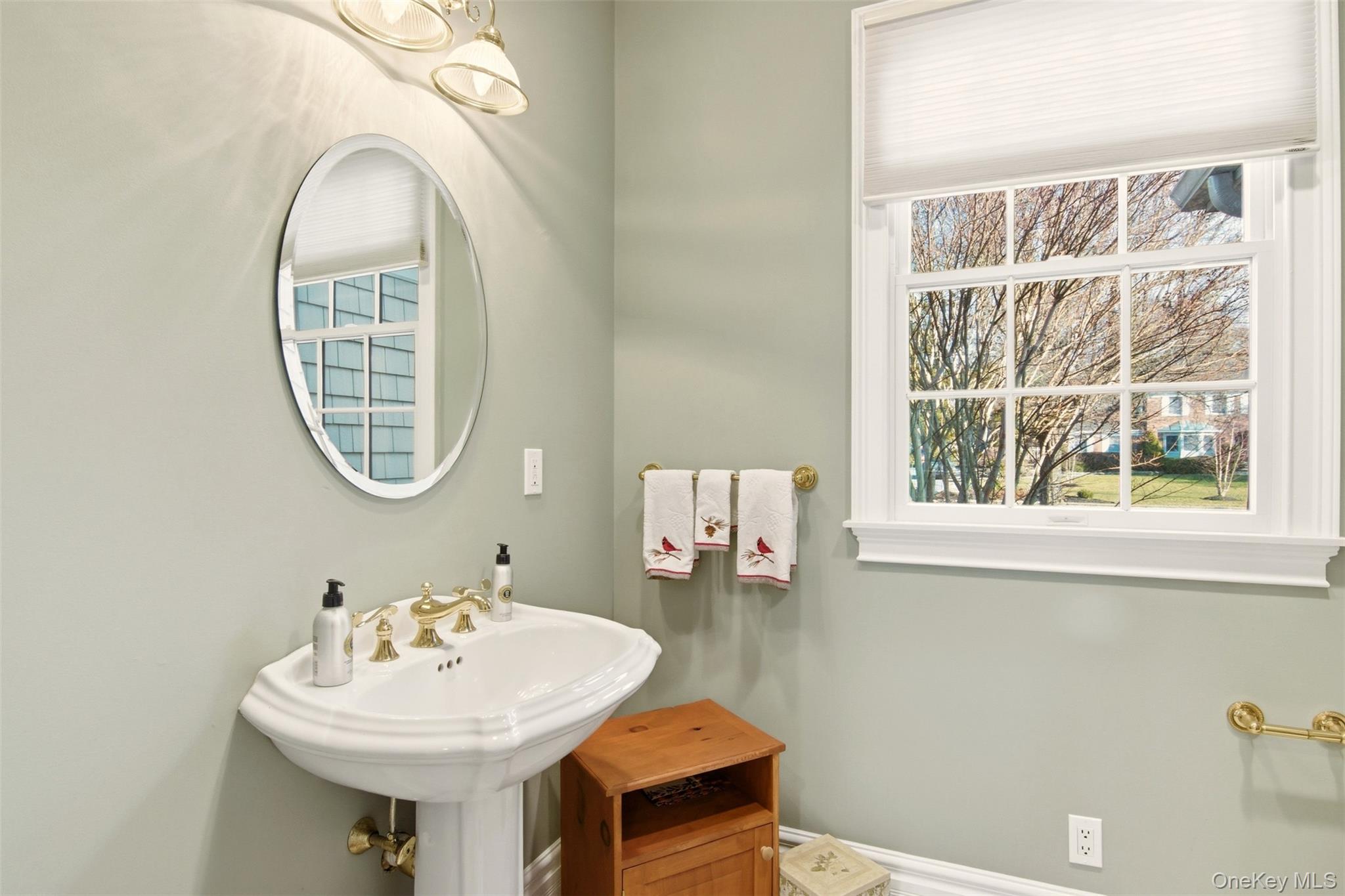 4 Daniel Way Setauket, NY 11733 - Photo 24 of 50 a bathroom with a sink a mirror and a window