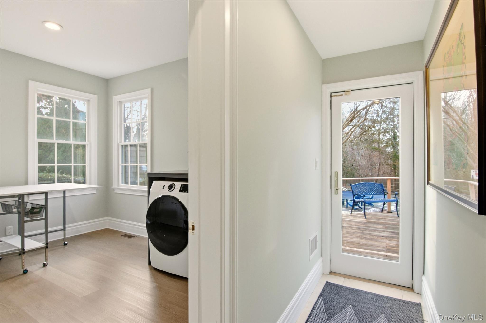 4 Daniel Way Setauket, NY 11733 - Photo 25 of 50 a view of a hallway with wooden floor and windows