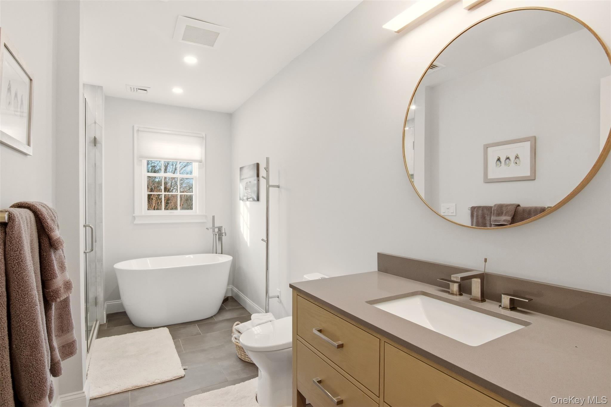 4 Daniel Way Setauket, NY 11733 - Photo 30 of 50 a bathroom with a granite countertop sink mirror vanity bathtub and a toilet