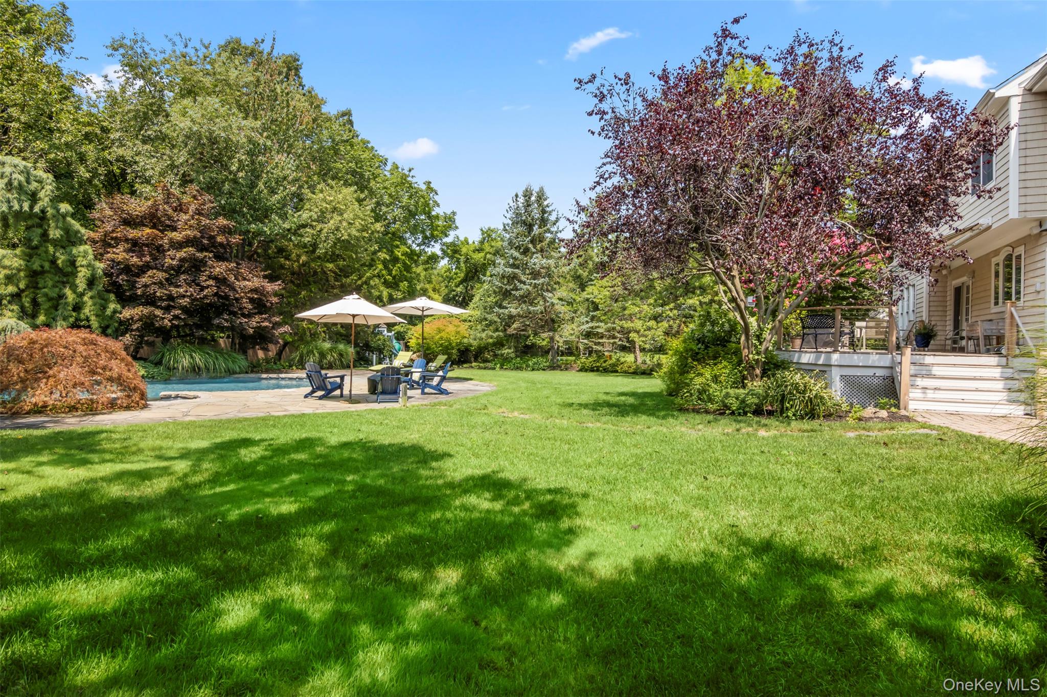 4 Daniel Way Setauket, NY 11733 - Photo 44 of 50 a view of a swimming pool with a yard and sitting area