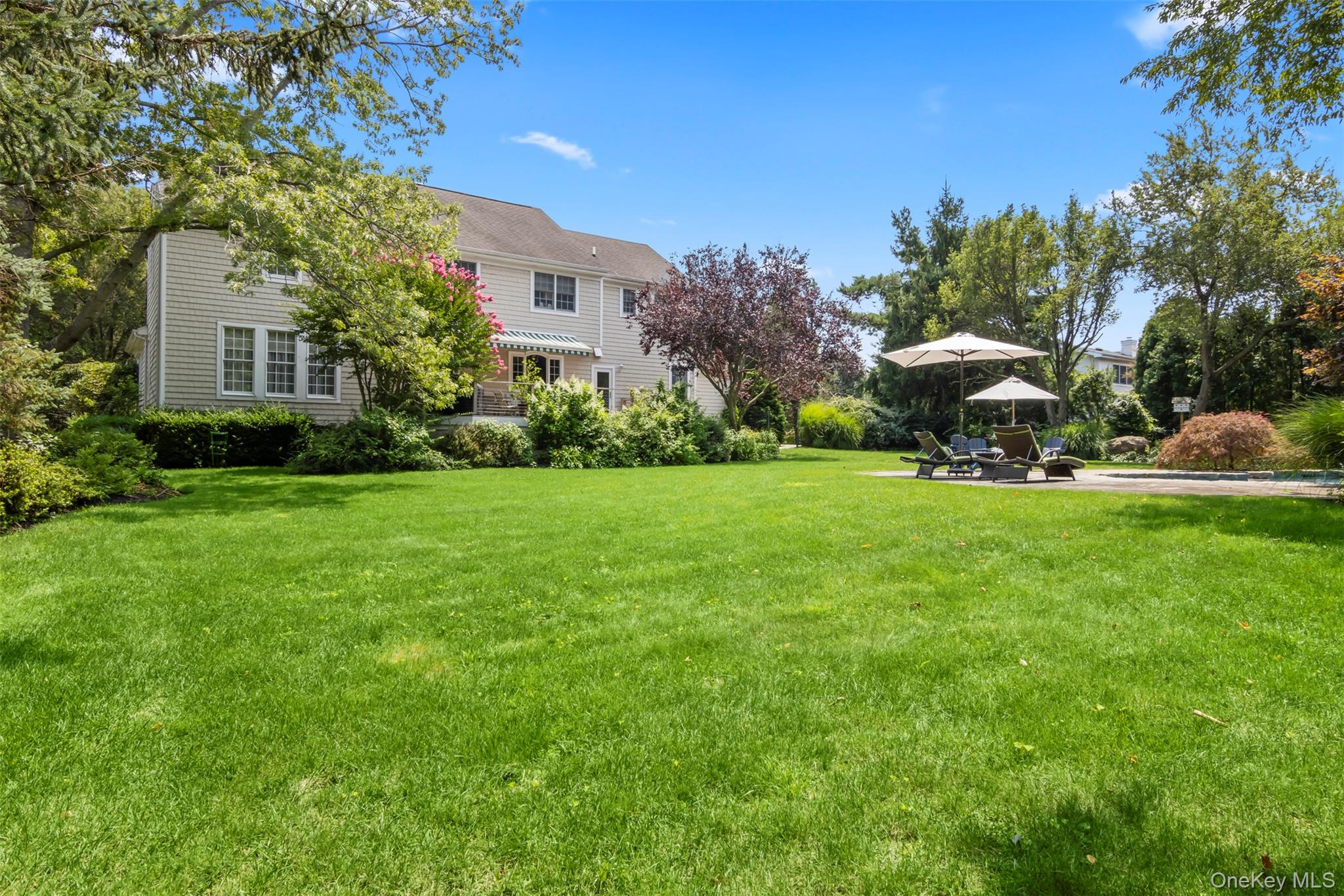 4 Daniel Way Setauket, NY 11733 - Photo 46 of 50 a front view of a house with garden and trees