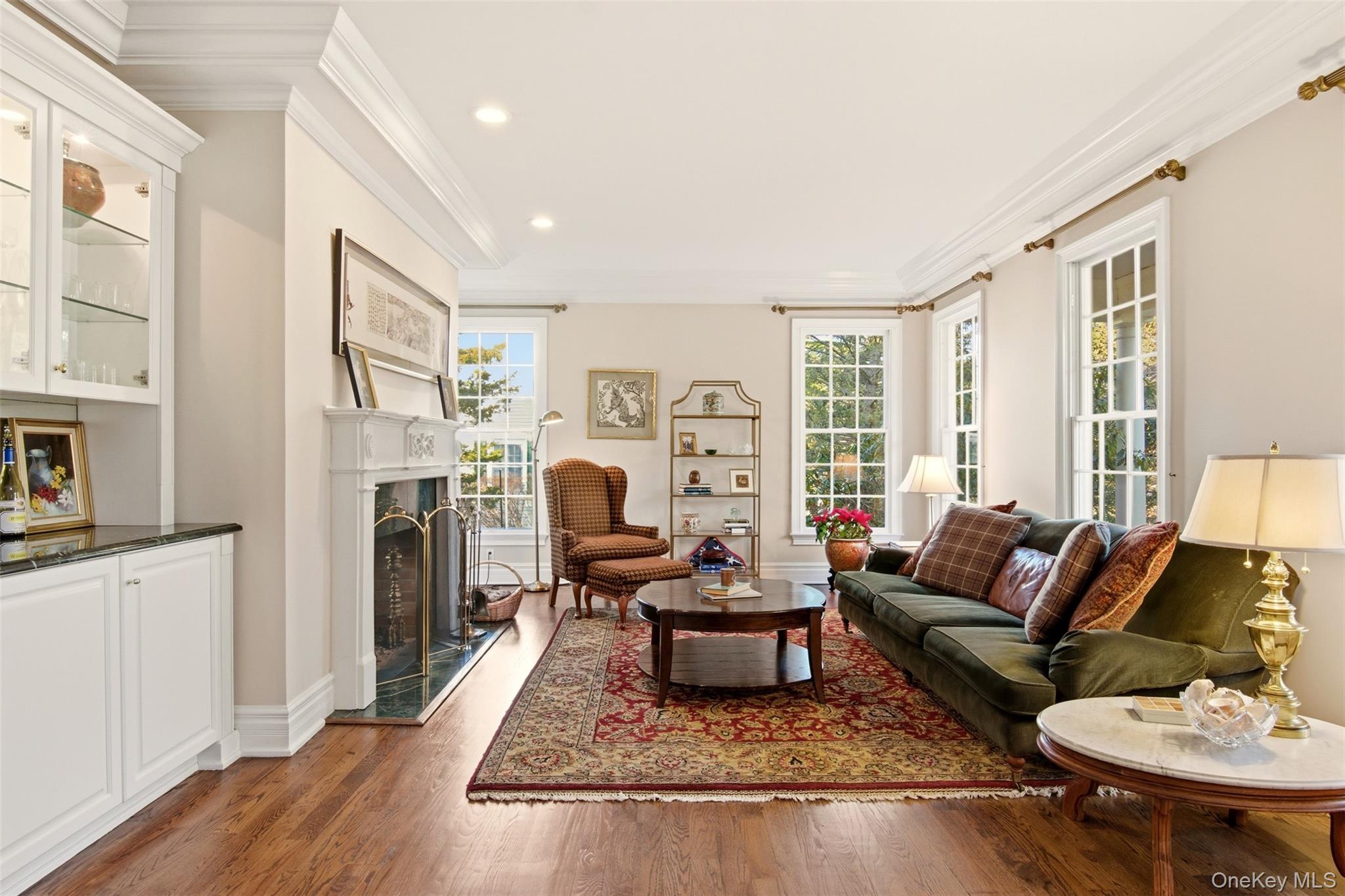4 Daniel Way Setauket, NY 11733 - Photo 7 of 50 a living room with furniture and a fireplace
