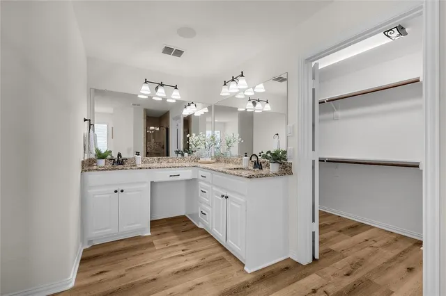 a spacious bathroom with a double vanity sink and a mirror